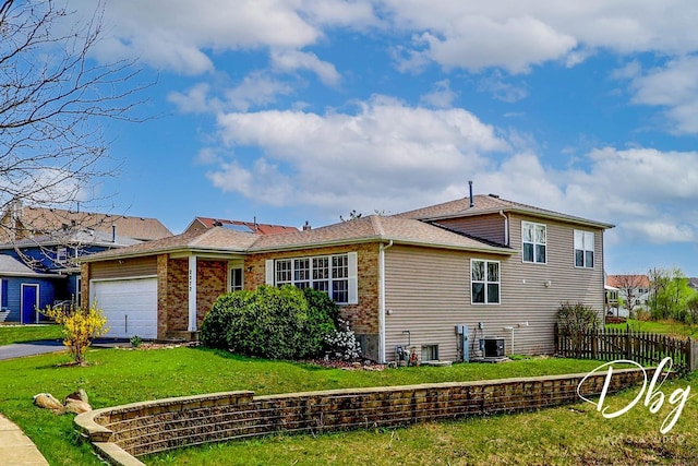 2272 Iroquois Ln, Round Lake Heights, IL 60073 - view of front facade with a front yard, a garage, fence, cooling unit, and aphalt driveway