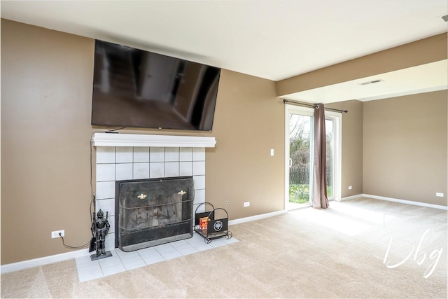 2272 Iroquois Ln, Round Lake Heights, IL 60073 - unfurnished living room featuring a tiled fireplace, baseboards, carpet, and visible vents