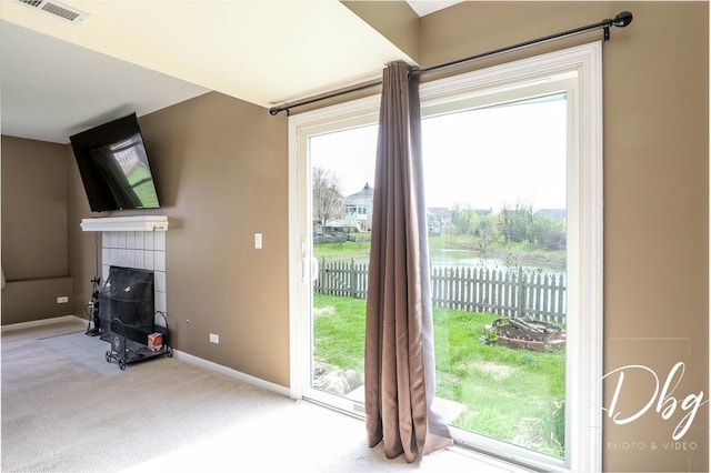 2272 Iroquois Ln, Round Lake Heights, IL 60073 - entryway featuring visible vents, a tile fireplace, baseboards, a water view, and carpet flooring