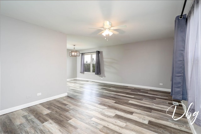 2272 Iroquois Ln, Round Lake Heights, IL 60073 - unfurnished room featuring baseboards, wood finished floors, and ceiling fan with notable chandelier