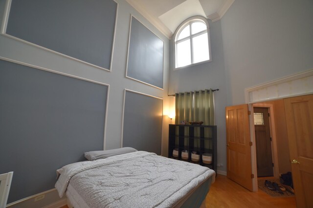 bedroom with high vaulted ceiling, ornamental molding, and a ceiling fan