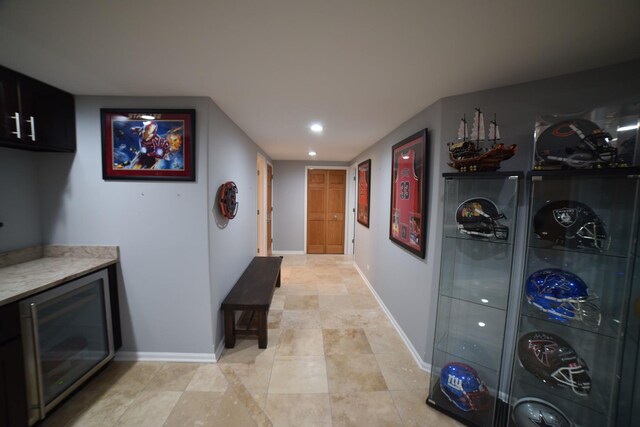 bar featuring a sink, baseboards, recessed lighting, and stairway