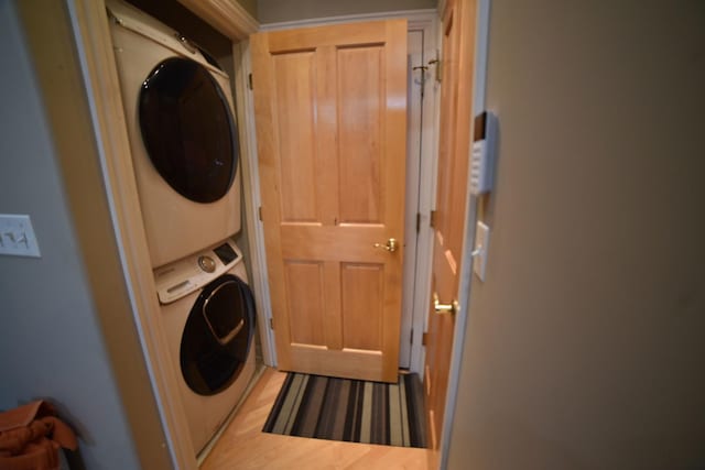 washroom featuring stacked washer / dryer