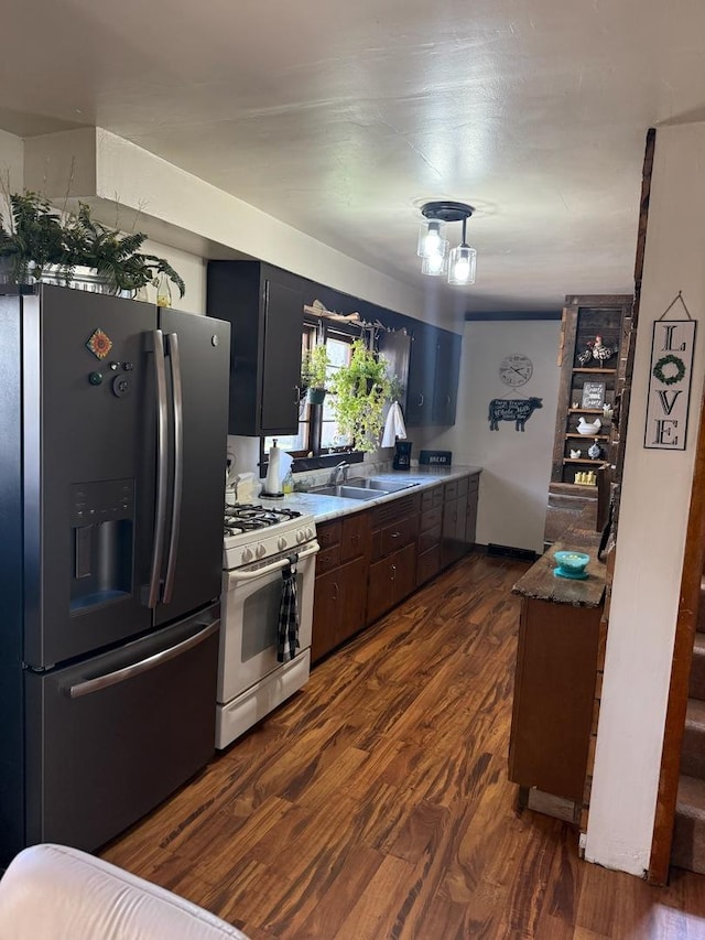 1605 14th Ave, Rock Falls, IL 61071 - kitchen featuring fridge with ice dispenser, white gas range, dark wood-style flooring, and a sink