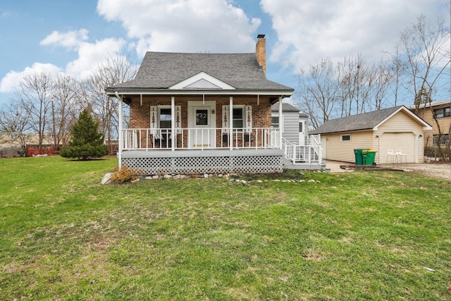view of front of home featuring a front lawn, a garage, an outbuilding, covered porch, and a chimney