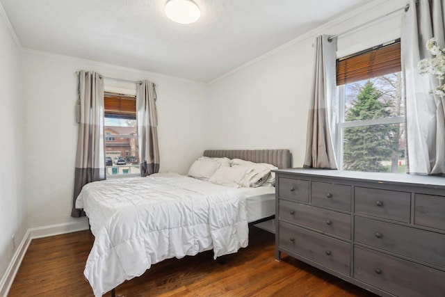 bedroom with dark wood-style flooring, crown molding, and multiple windows