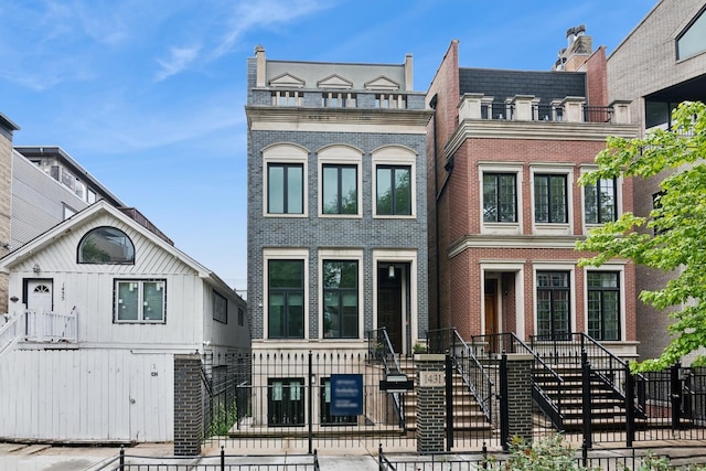 1431 N Mohawk St, Chicago, IL 60610 - townhome / multi-family property featuring a fenced front yard and brick siding
