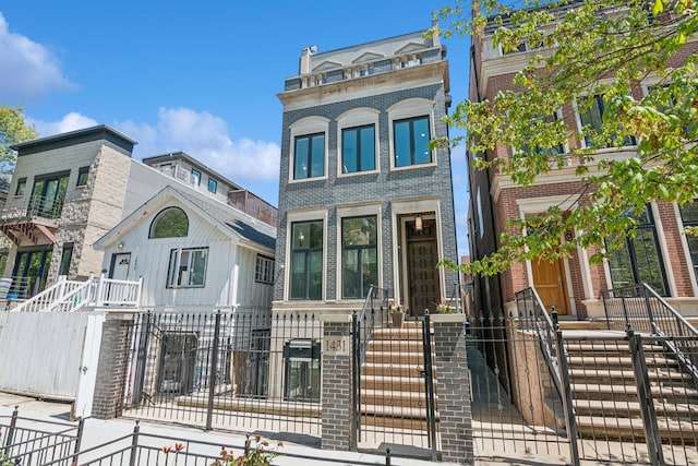 1431 N Mohawk St, Chicago, IL 60610 - townhome / multi-family property featuring a fenced front yard, brick siding, and a gate