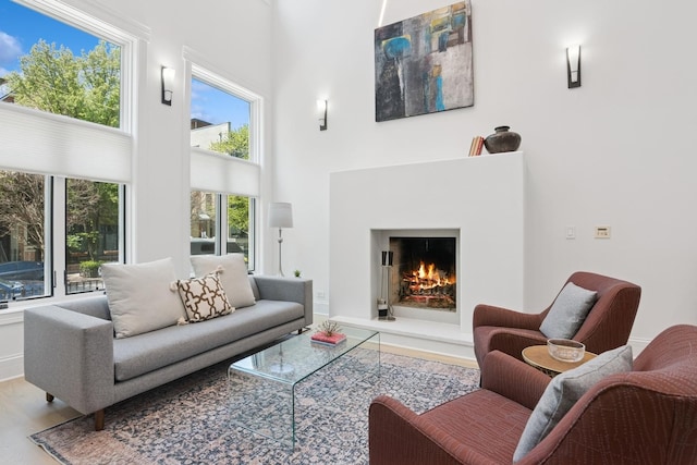 1431 N Mohawk St, Chicago, IL 60610 - living area featuring wood finished floors, a high ceiling, and a warm lit fireplace