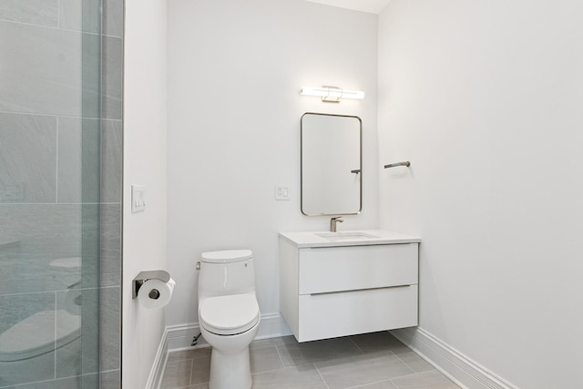1431 N Mohawk St, Chicago, IL 60610 - bathroom featuring toilet, vanity, a tile shower, tile patterned floors, and baseboards