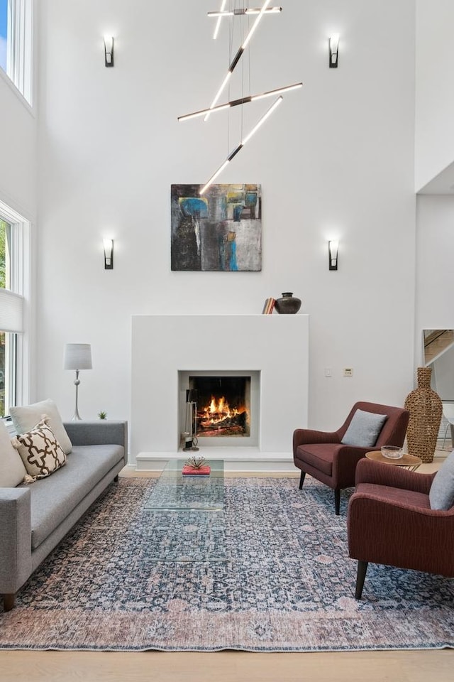1431 N Mohawk St, Chicago, IL 60610 - living area with a towering ceiling, a lit fireplace, and wood finished floors