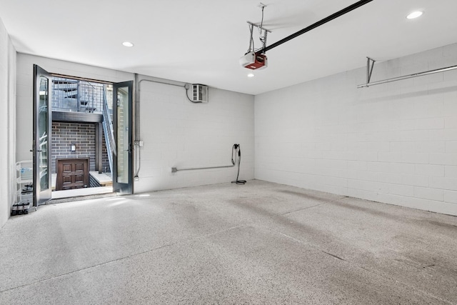 1431 N Mohawk St, Chicago, IL 60610 - garage with concrete block wall, a garage door opener, and recessed lighting