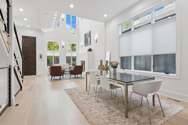 1431 N Mohawk St, Chicago, IL 60610 - dining space featuring plenty of natural light, stairs, wood finished floors, recessed lighting, and a high ceiling