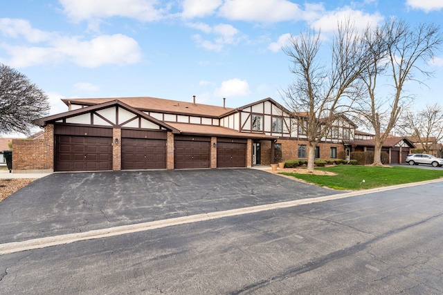 9810 Mill Dr W Unit 1B, Palos Park, IL 60464 - english style home featuring driveway, a front lawn, brick siding, and stucco siding