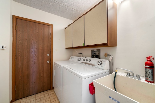 9810 Mill Dr W Unit 1B, Palos Park, IL 60464 - clothes washing area featuring a sink, a textured ceiling, independent washer and dryer, cabinet space, and light floors