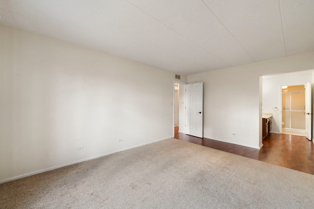9810 Mill Dr W Unit 1B, Palos Park, IL 60464 - spare room with visible vents, dark colored carpet, and baseboards