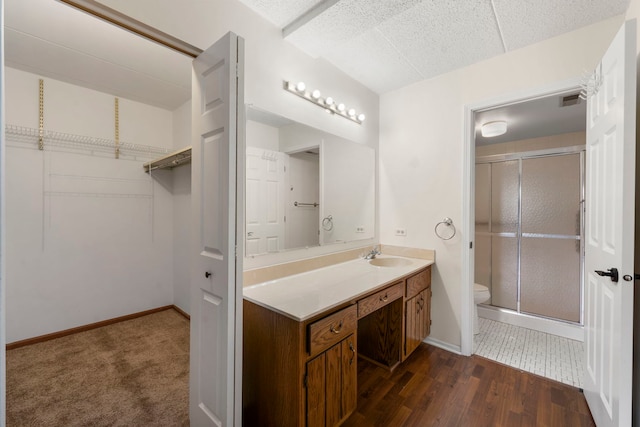 9810 Mill Dr W Unit 1B, Palos Park, IL 60464 - full bath with baseboards, toilet, vanity, and a stall shower