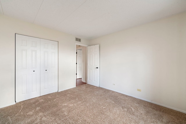 9810 Mill Dr W Unit 1B, Palos Park, IL 60464 - unfurnished bedroom featuring baseboards, a closet, visible vents, and carpet