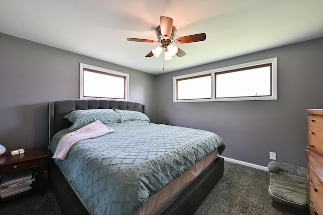 bedroom with a ceiling fan, baseboards, and dark carpet