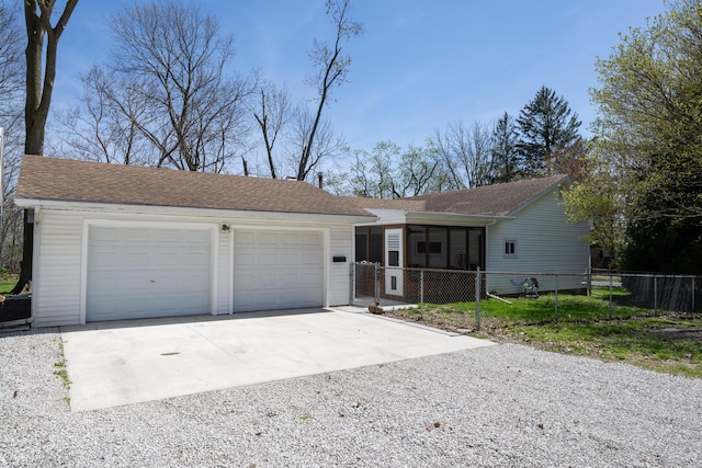 single story home with fence, roof with shingles, a garage, a sunroom, and gravel driveway