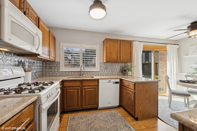2828 Ashton Ct, Westchester, IL 60154 - kitchen featuring brown cabinets, decorative backsplash, a sink, and white appliances