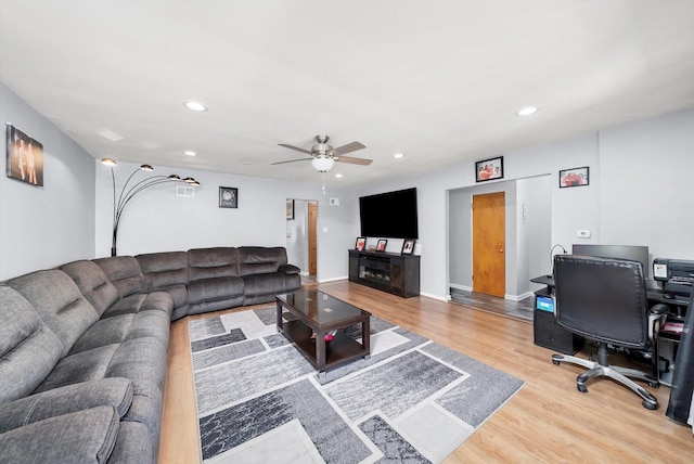 living room with a ceiling fan, light wood-type flooring, and recessed lighting