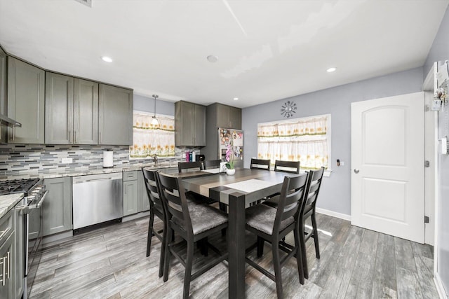 dining space with light wood-style floors, recessed lighting, and baseboards