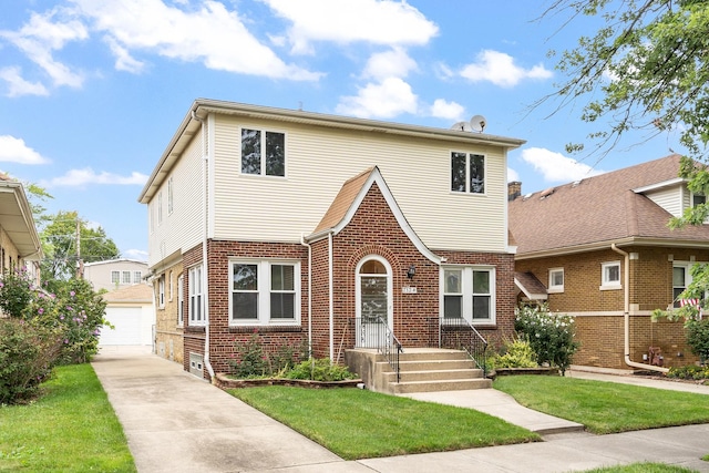7324 W Lunt Ave, Chicago, IL 60631 - view of front facade featuring an outdoor structure, brick siding, a detached garage, and a front yard