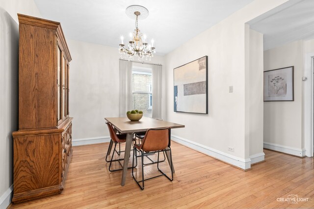 7324 W Lunt Ave, Chicago, IL 60631 - dining area with baseboards, an inviting chandelier, and light wood-style floors