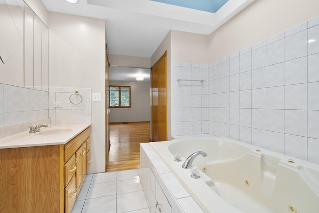 7324 W Lunt Ave, Chicago, IL 60631 - full bathroom with tile walls, a jetted tub, tile patterned flooring, and vanity