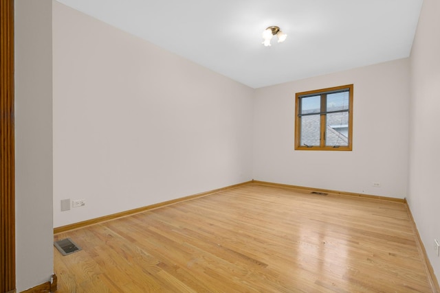 7324 W Lunt Ave, Chicago, IL 60631 - spare room featuring visible vents, baseboards, and wood finished floors