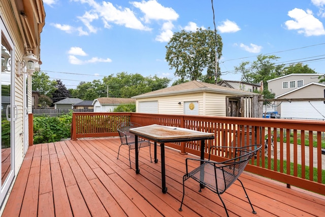 7324 W Lunt Ave, Chicago, IL 60631 - wooden terrace with a detached garage, outdoor dining space, and an outbuilding