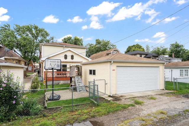 7324 W Lunt Ave, Chicago, IL 60631 - view of front facade featuring fence, a wooden deck, an outdoor structure, and a garage