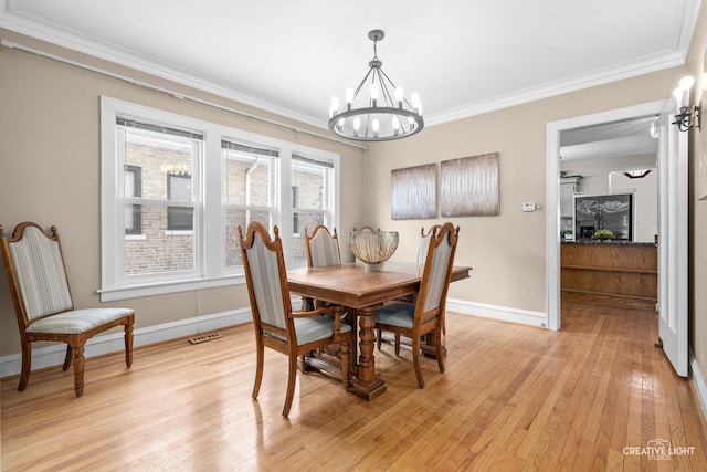 7324 W Lunt Ave, Chicago, IL 60631 - dining space featuring visible vents, baseboards, light wood-style floors, a chandelier, and ornamental molding