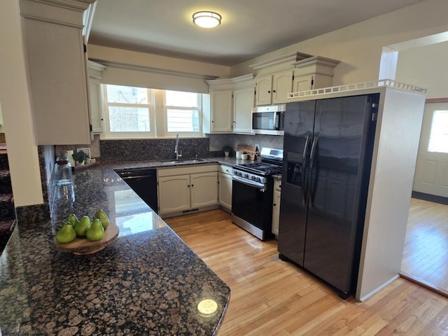 7324 W Lunt Ave, Chicago, IL 60631 - kitchen with light wood-style flooring, a sink, backsplash, and black appliances