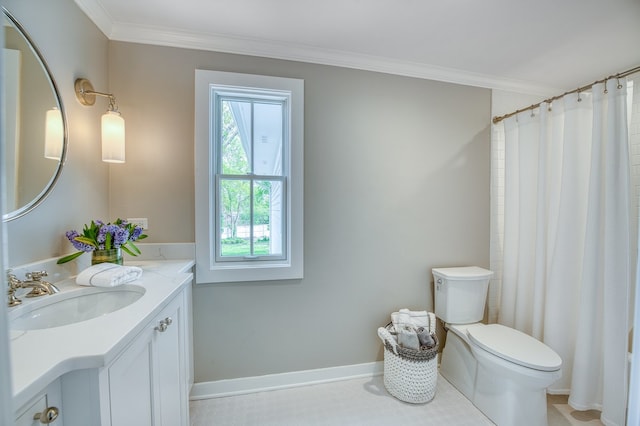bathroom featuring crown molding, toilet, plenty of natural light, and vanity