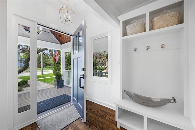 mudroom featuring crown molding, an inviting chandelier, dark wood finished floors, baseboards, and lofted ceiling