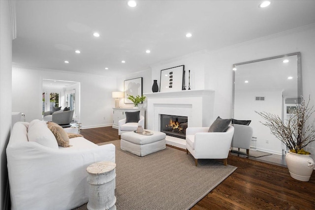 living area featuring crown molding, recessed lighting, wood finished floors, and visible vents