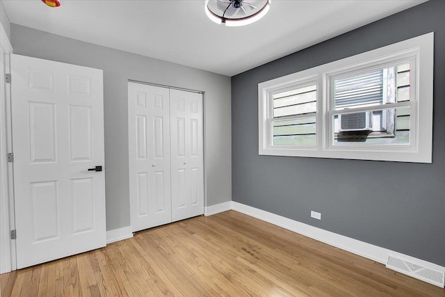 314 W 106th Pl, Chicago, IL 60628 - unfurnished bedroom featuring baseboards, light wood finished floors, a closet, and cooling unit