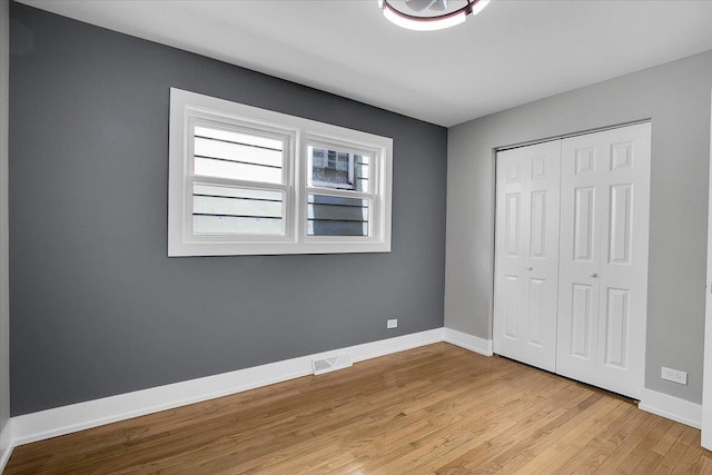 314 W 106th Pl, Chicago, IL 60628 - unfurnished bedroom with light wood-style flooring, a closet, and baseboards