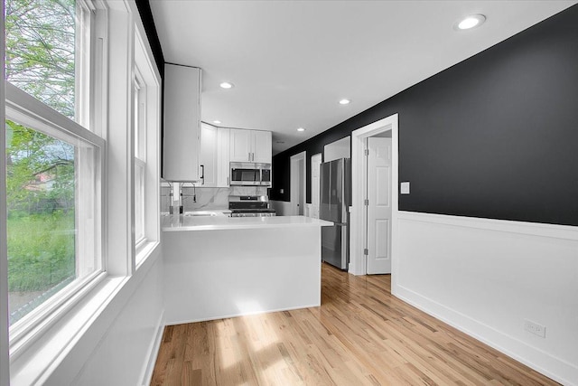 314 W 106th Pl, Chicago, IL 60628 - kitchen with stainless steel appliances, a sink, healthy amount of natural light, white cabinets, and recessed lighting