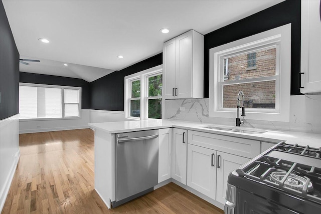 314 W 106th Pl, Chicago, IL 60628 - kitchen with dishwasher, a sink, black range with gas stovetop, light wood finished floors, and white cabinetry