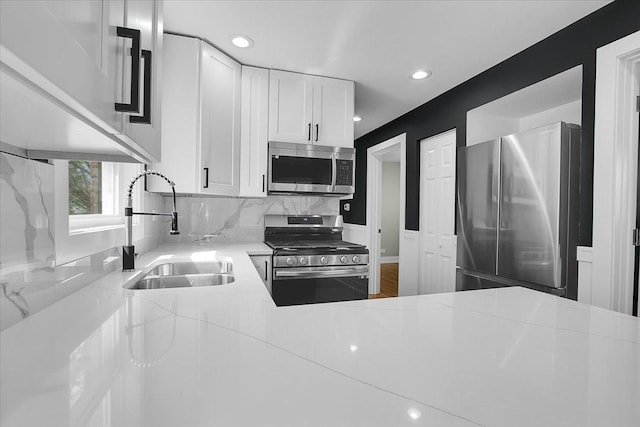 314 W 106th Pl, Chicago, IL 60628 - kitchen featuring appliances with stainless steel finishes, a sink, light countertops, white cabinets, and recessed lighting