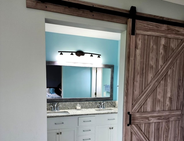 full bath featuring a sink, double vanity, toilet, and a stall shower