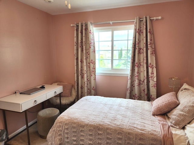 carpeted bedroom featuring baseboards and visible vents