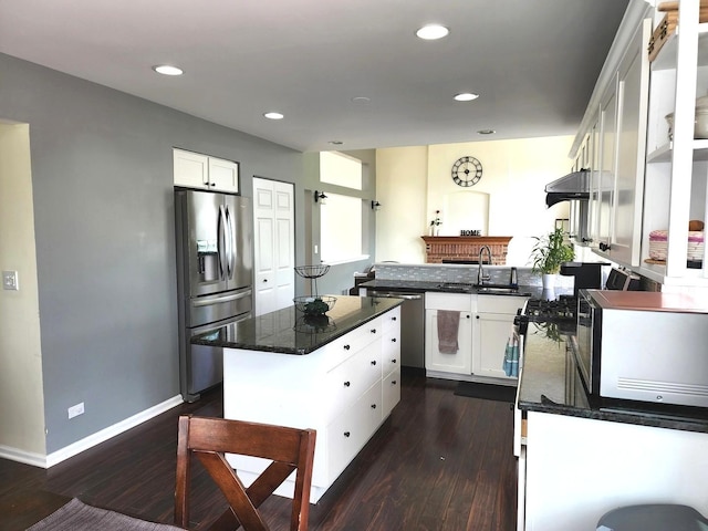 interior space featuring a center island, white cabinets, baseboards, dark wood-style floors, and recessed lighting