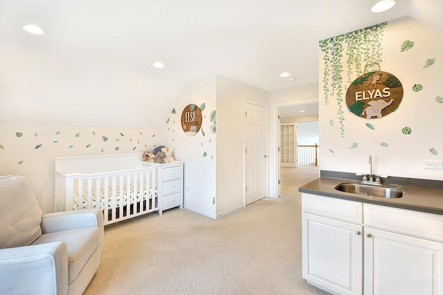 bedroom with vaulted ceiling, a sink, light carpet, baseboards, and recessed lighting