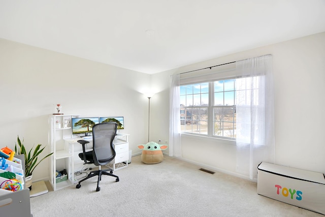 office with baseboards, visible vents, and carpet