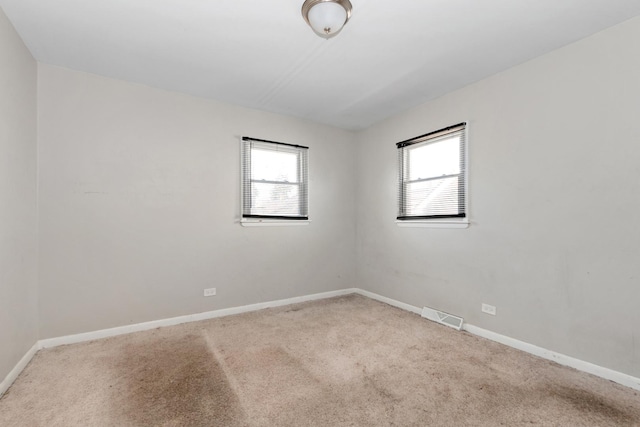 742 Newell Ave, Calumet City, IL 60409 - carpeted spare room featuring baseboards, visible vents, and plenty of natural light