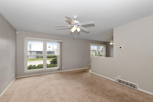 742 Newell Ave, Calumet City, IL 60409 - carpeted spare room with a ceiling fan, visible vents, and a healthy amount of sunlight